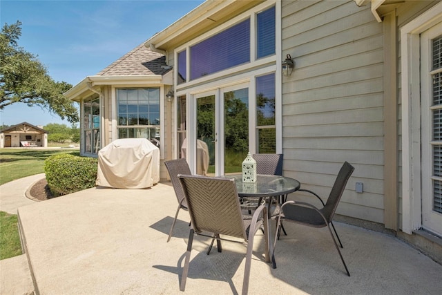 view of patio featuring outdoor dining area and a grill