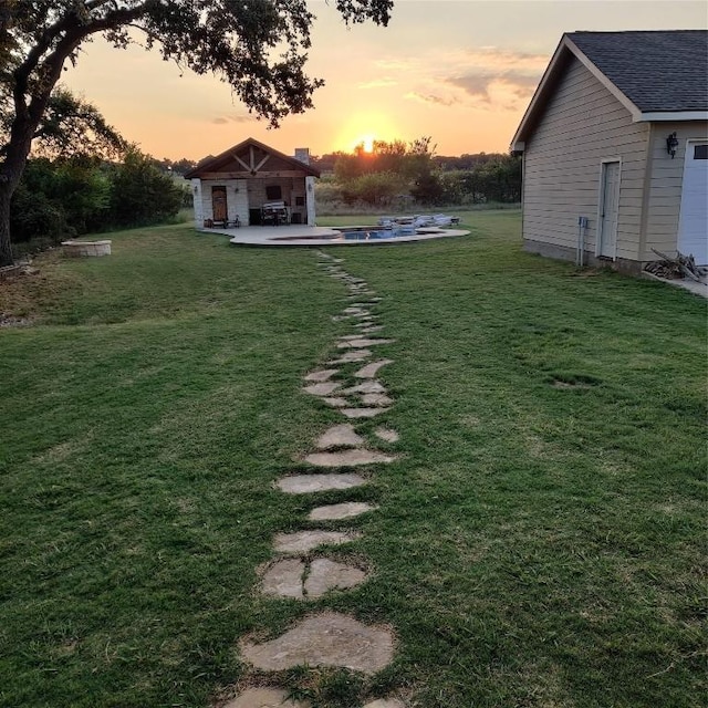 yard at dusk featuring a patio