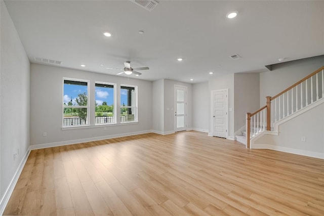503 Emory Crossing Blvd, Hutto, TX 78634 - unfurnished living room featuring light wood-style flooring, stairs, baseboards, and recessed lighting