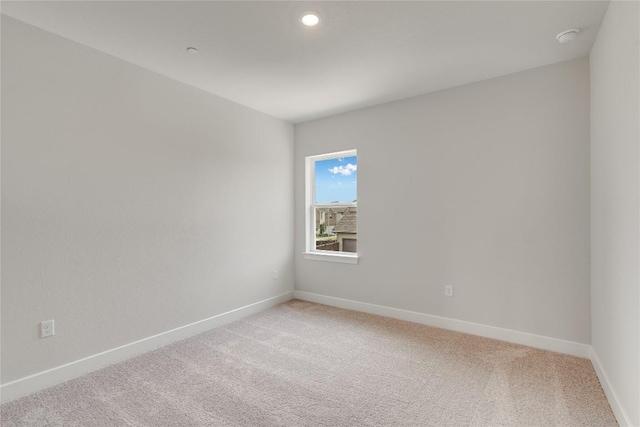 503 Emory Crossing Blvd, Hutto, TX 78634 - spare room featuring light colored carpet, baseboards, a smoke detector, and recessed lighting