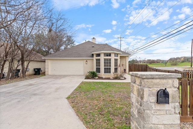 single story home featuring fence, roof with shingles, concrete driveway, a garage, and a chimney