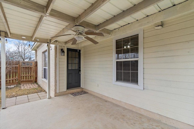 property entrance featuring a patio area, ceiling fan, and fence