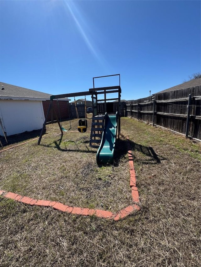 view of playground featuring fence