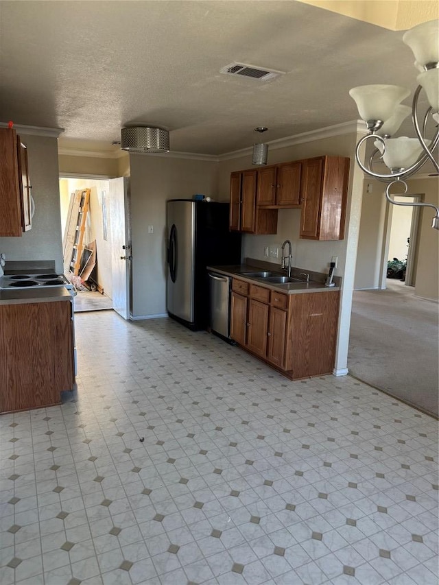 kitchen featuring a sink, visible vents, stainless steel appliances, and ornamental molding