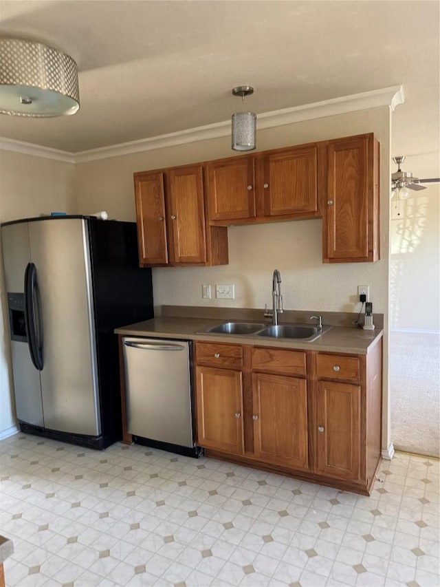 kitchen with a sink, appliances with stainless steel finishes, and brown cabinetry