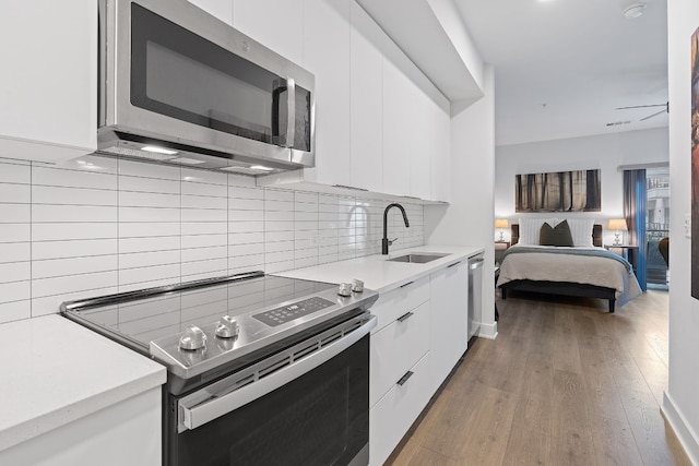 2220 Webberville Rd Unit 225, Austin, TX 78702 - kitchen featuring stainless steel appliances, a sink, modern cabinets, and white cabinets