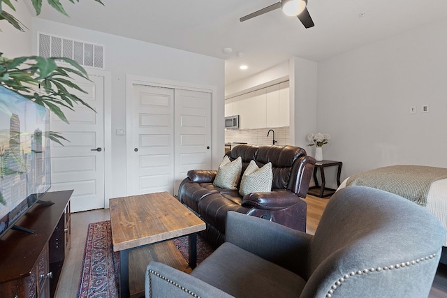 2220 Webberville Rd Unit 225, Austin, TX 78702 - living room featuring wood finished floors, a ceiling fan, and recessed lighting