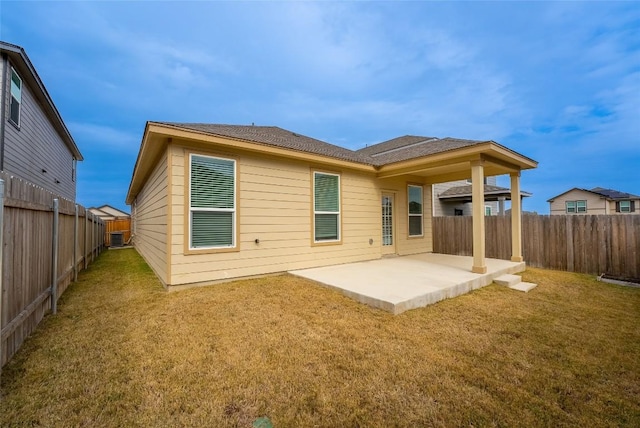 back of property featuring a patio area, a yard, and a fenced backyard