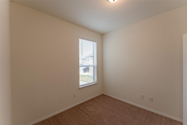 unfurnished room featuring baseboards and carpet floors