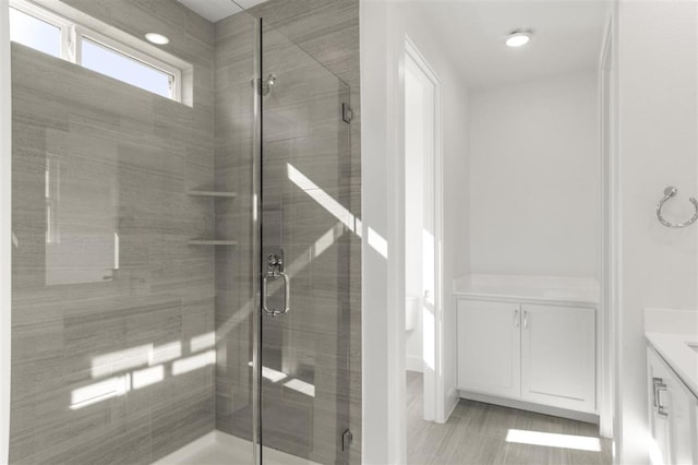 bathroom featuring a shower stall and vanity