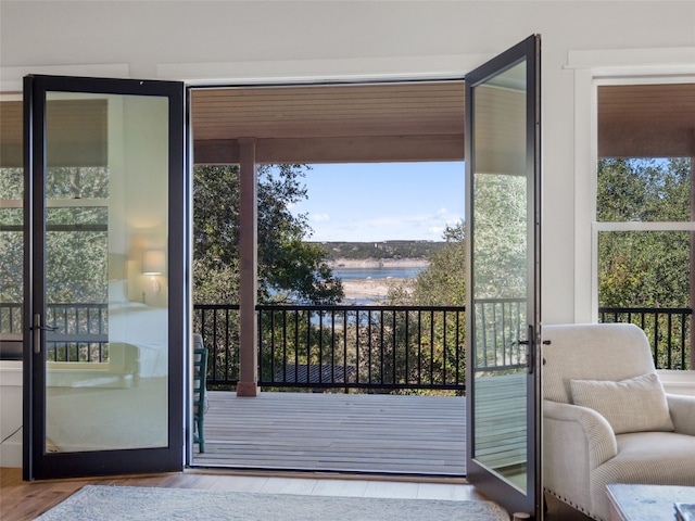 doorway with wood finished floors and a water view