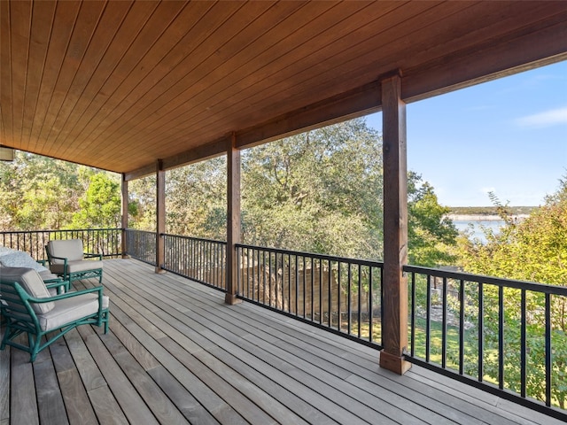 wooden deck featuring a water view