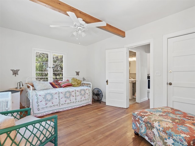 bedroom featuring beamed ceiling and wood finished floors