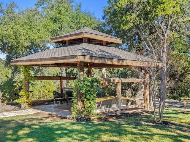 view of property's community with a gazebo and a yard