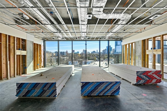 unfurnished bedroom with a city view and concrete floors