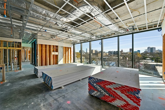 misc room featuring a view of city and unfinished concrete flooring