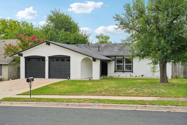 ranch-style house with brick siding, a front lawn, concrete driveway, roof with shingles, and an attached garage