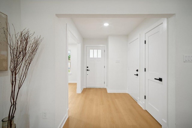 hallway with baseboards and light wood-style floors