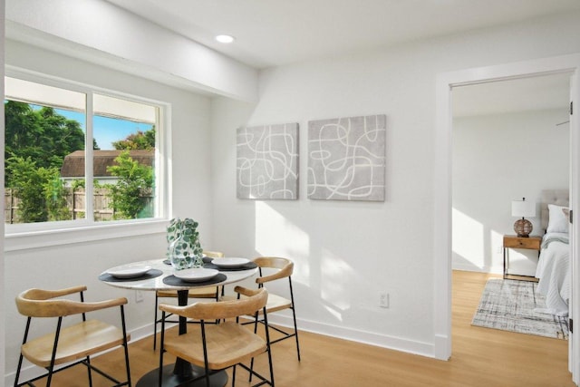 dining area with recessed lighting, baseboards, and wood finished floors