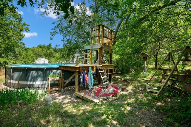 view of jungle gym with an outdoor pool