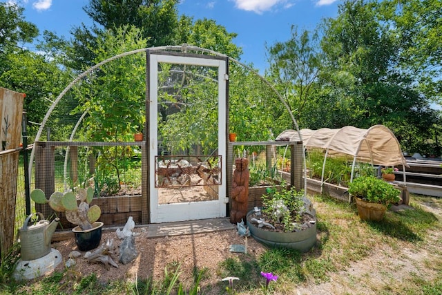 exterior space featuring a garden and an outbuilding