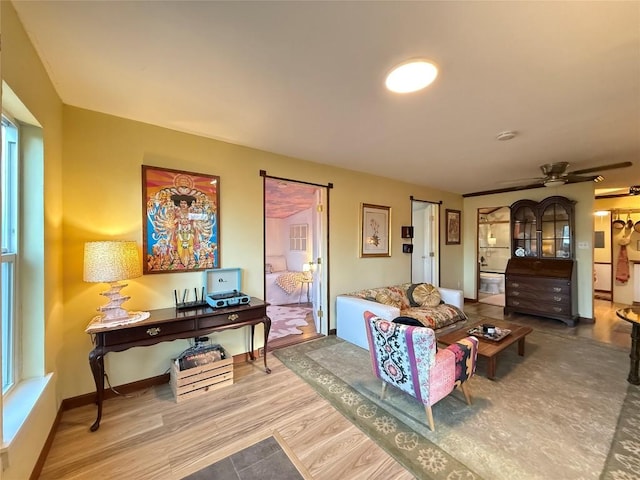 living room featuring wood finished floors and baseboards