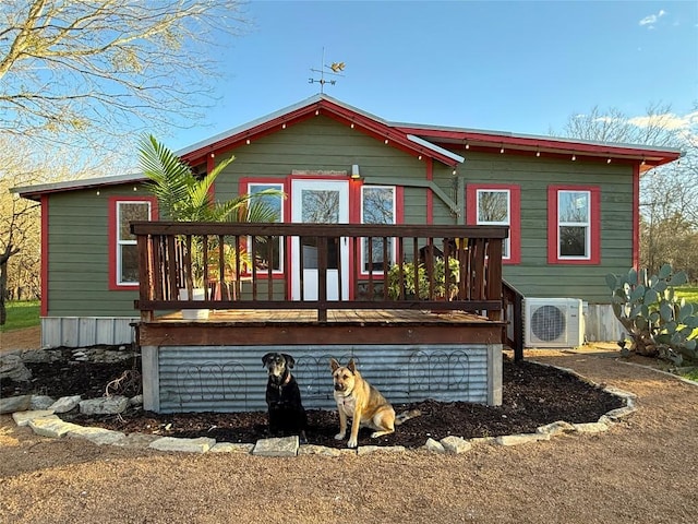 back of house with a deck and ac unit