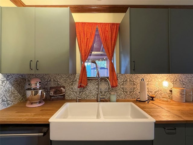 kitchen featuring a sink, decorative backsplash, dishwashing machine, and butcher block counters