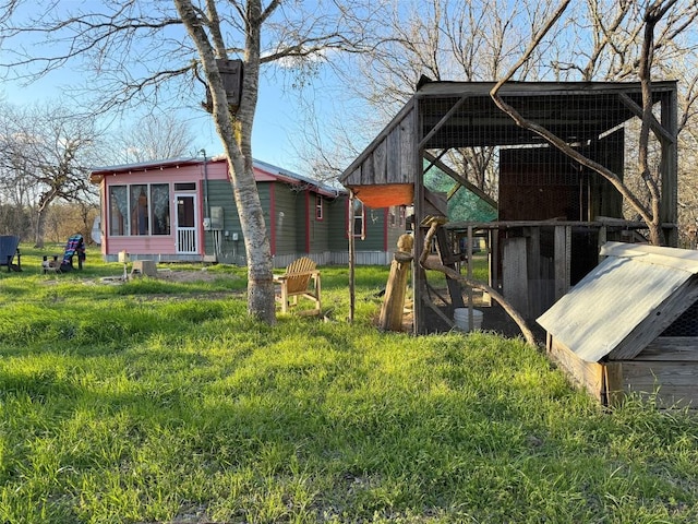 exterior space with a carport, an outbuilding, and exterior structure