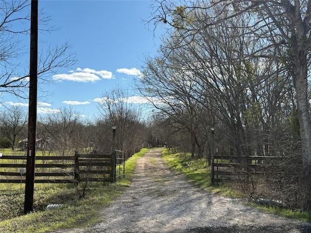 view of road with a gated entry