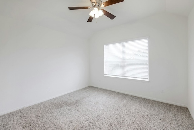 spare room with baseboards, lofted ceiling, carpet floors, and a ceiling fan