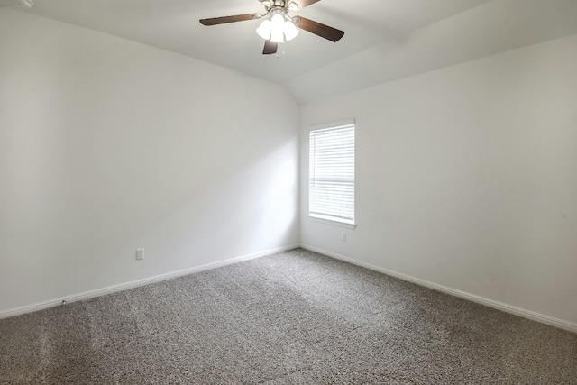 empty room with carpet flooring, ceiling fan, baseboards, and lofted ceiling