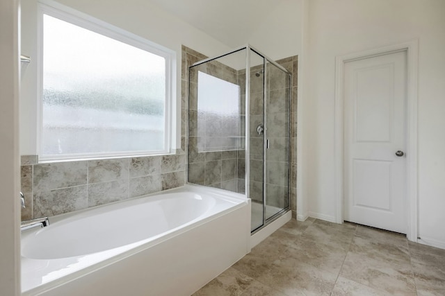 full bathroom featuring a garden tub and a stall shower