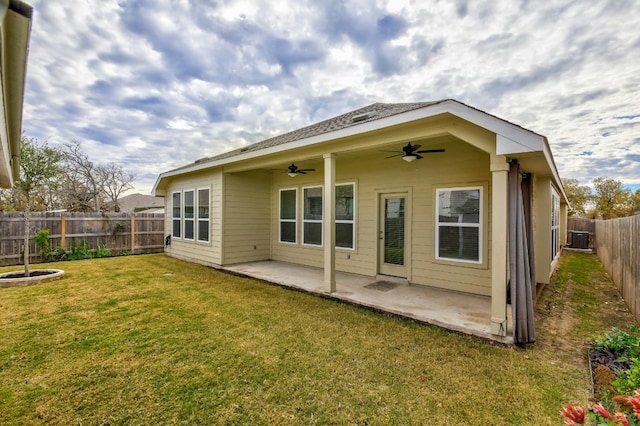 back of property with ceiling fan, central AC unit, a yard, a fenced backyard, and a patio area