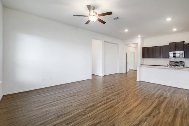 unfurnished living room with dark wood finished floors, recessed lighting, a ceiling fan, and visible vents