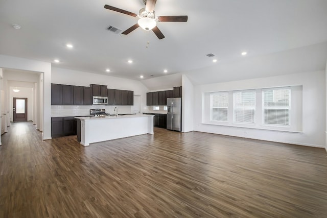 kitchen featuring open floor plan, appliances with stainless steel finishes, visible vents, and dark wood-style flooring