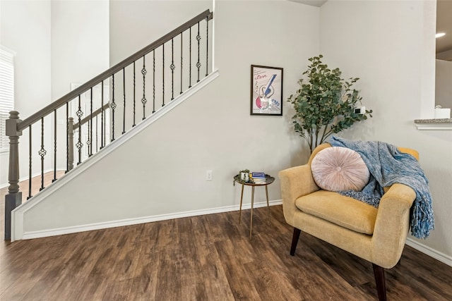 living area featuring stairs, wood finished floors, and baseboards