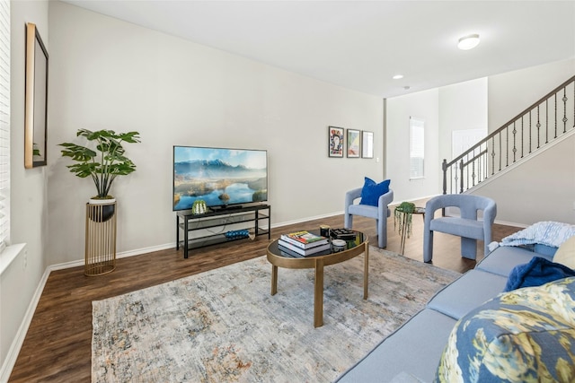 living room featuring recessed lighting, stairway, baseboards, and wood finished floors