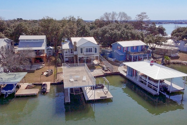 view of dock with stairway, a water view, boat lift, and a patio area