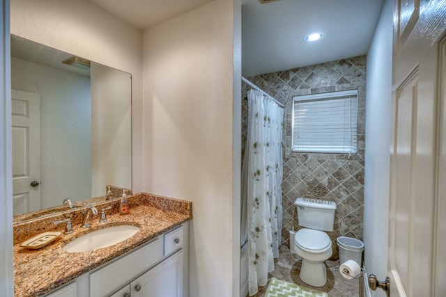 bathroom featuring curtained shower, toilet, and vanity