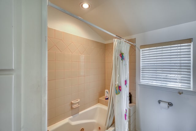 bathroom featuring vaulted ceiling, recessed lighting, and a combined bath / shower with jetted tub