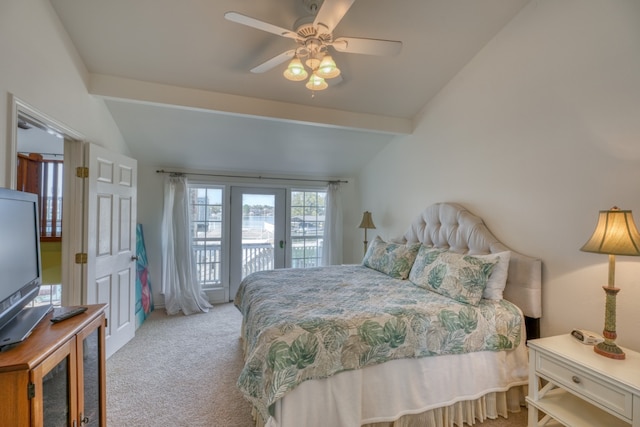 carpeted bedroom featuring a ceiling fan, vaulted ceiling, and access to exterior