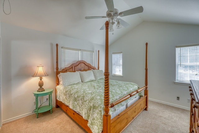 bedroom featuring lofted ceiling, multiple windows, and light colored carpet