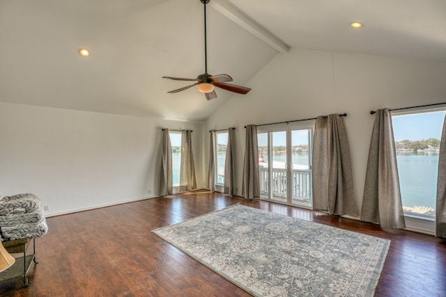 living area featuring beam ceiling, dark wood-style flooring, and a water view