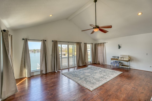 unfurnished living room featuring a ceiling fan, beam ceiling, wood finished floors, and high vaulted ceiling