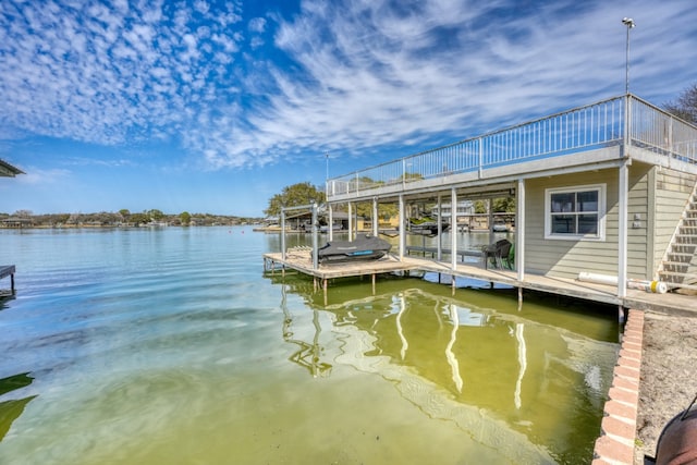 view of dock with boat lift and a water view