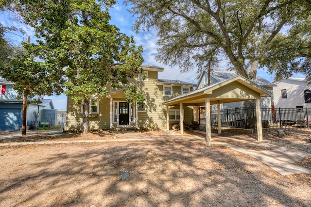 view of front facade featuring a carport and fence