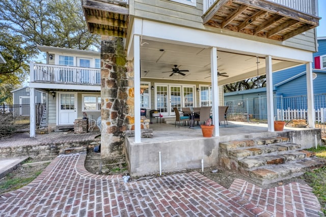 view of patio / terrace with french doors, ceiling fan, and fence