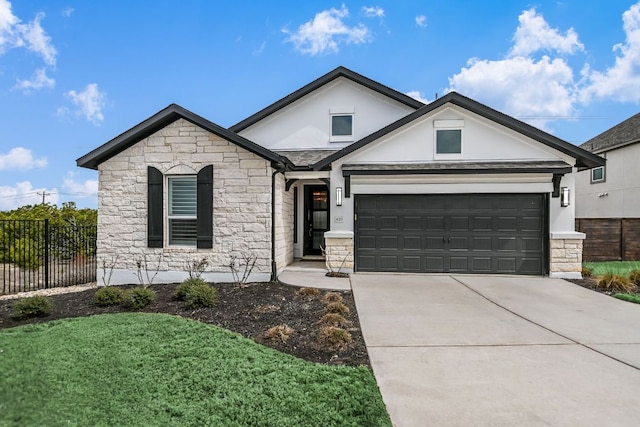 view of front of home with stone siding, stucco siding, driveway, and fence