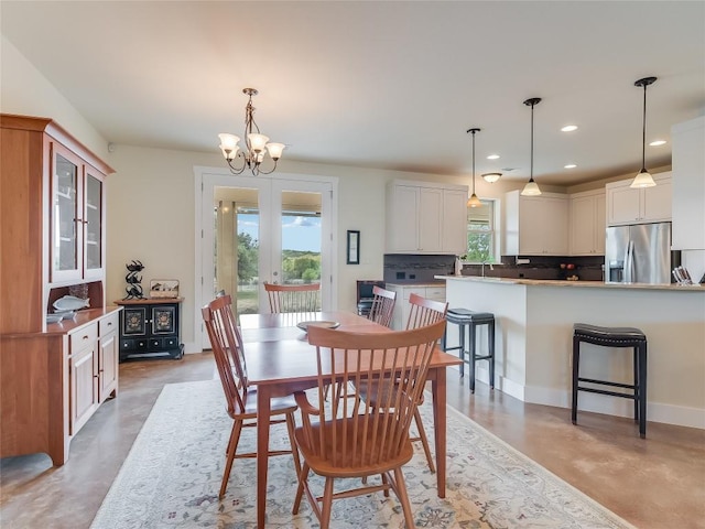 dining area with baseboards, an inviting chandelier, recessed lighting, finished concrete floors, and french doors